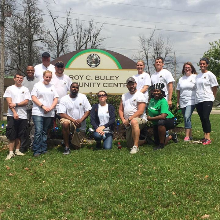 Members at the Roy C. Buley Center sign